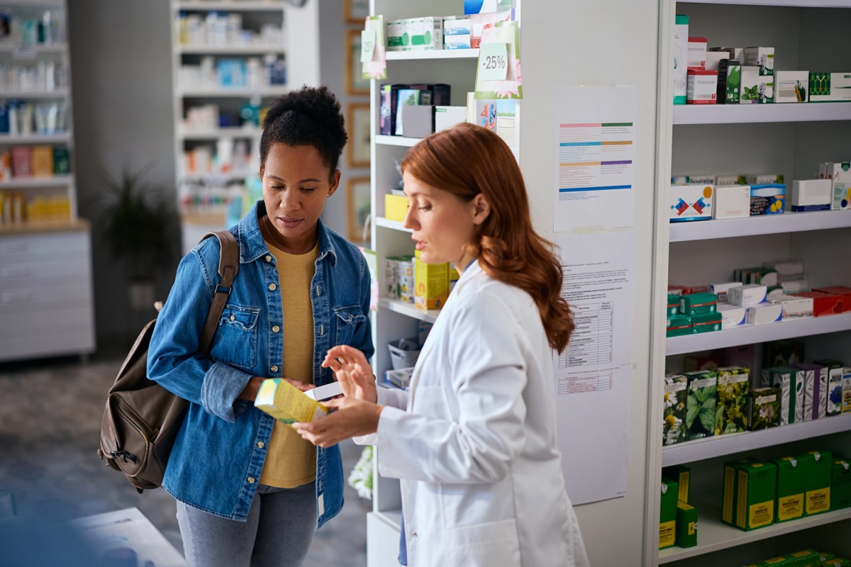 Pharmacist explaining a product to a customer in a pharmacy